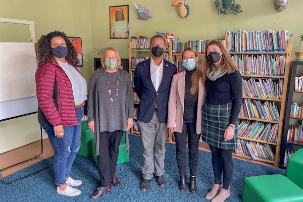 five masked people pose at Hamilton Families