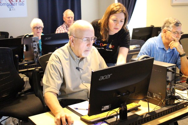 Google volunteer assisting learner at AGE.