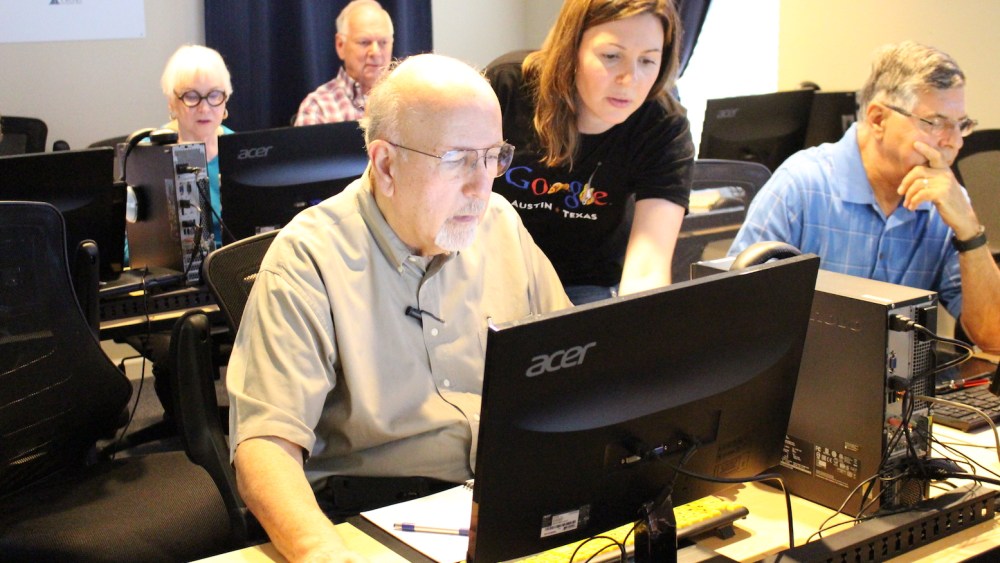 Google volunteer assisting learner at AGE.