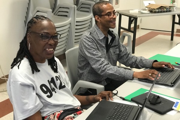 Two students participating in a laptop class in the Bayview of San Francisco